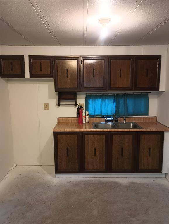 Kitchen sink Area recently painted with replaced wood look vinyl flooring.