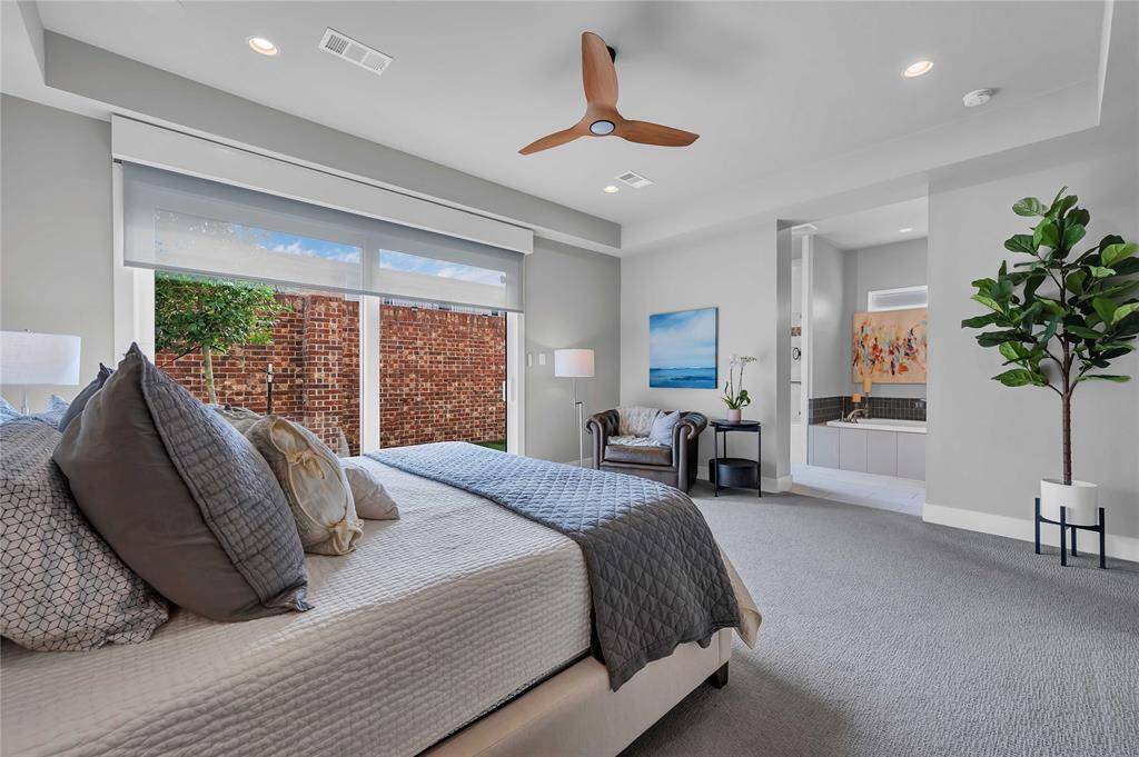 Experience the airy elegance of the sunlit primary suite.