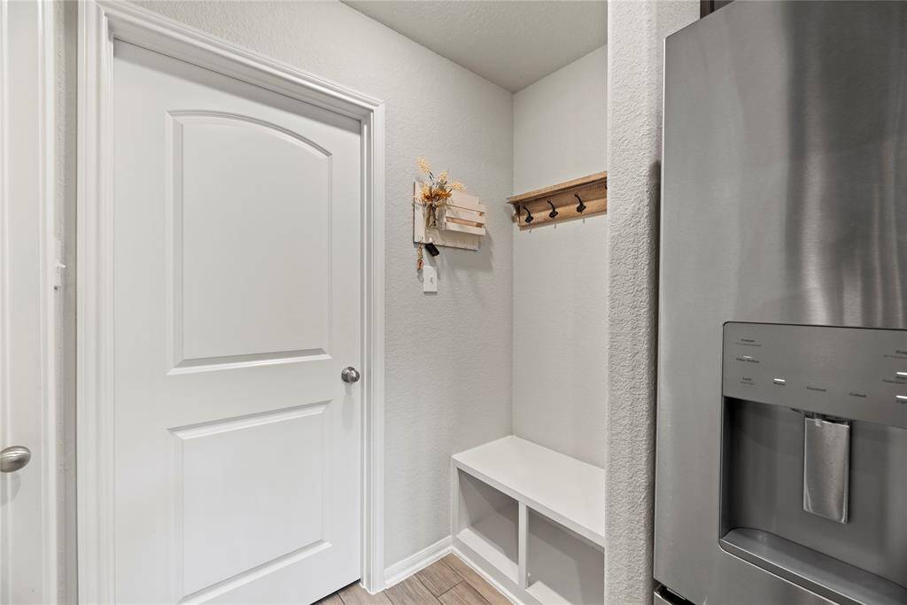From the kitchen, on the left is a walk-in pantry, on the right is a mudroom area and straight ahead is the door to the utility room.