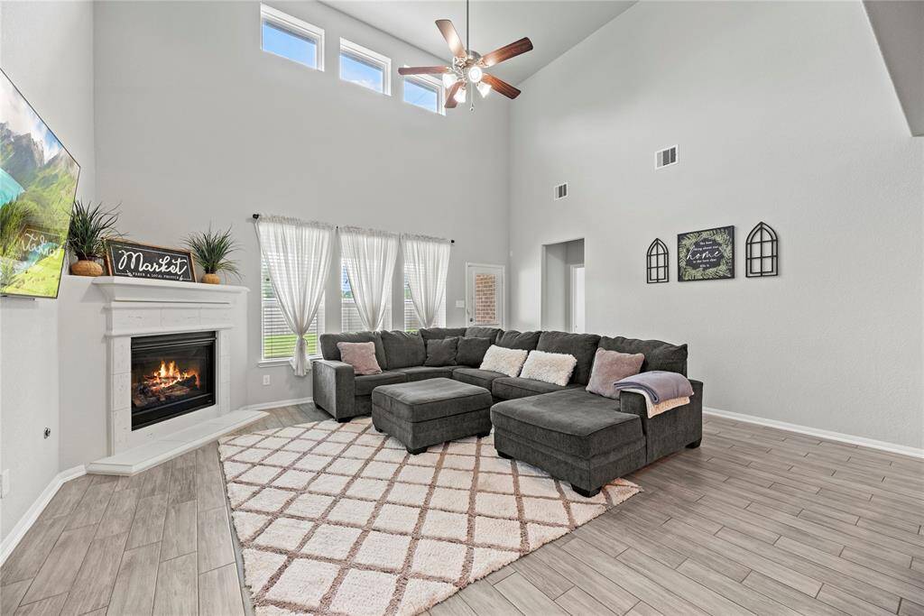 Two story living/family room features a gas log fireplace.