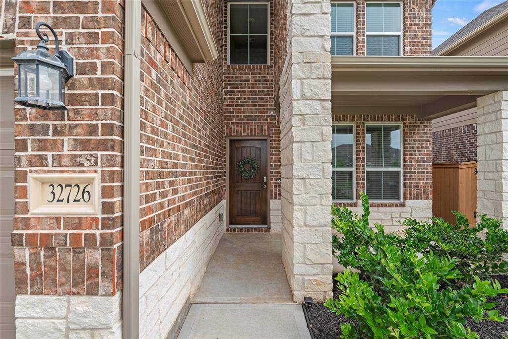 There is a covered front porch to the right of the front door.
