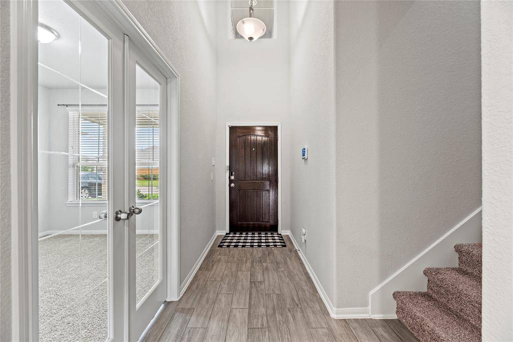 Inside view of entry with home office/study behind French doors.