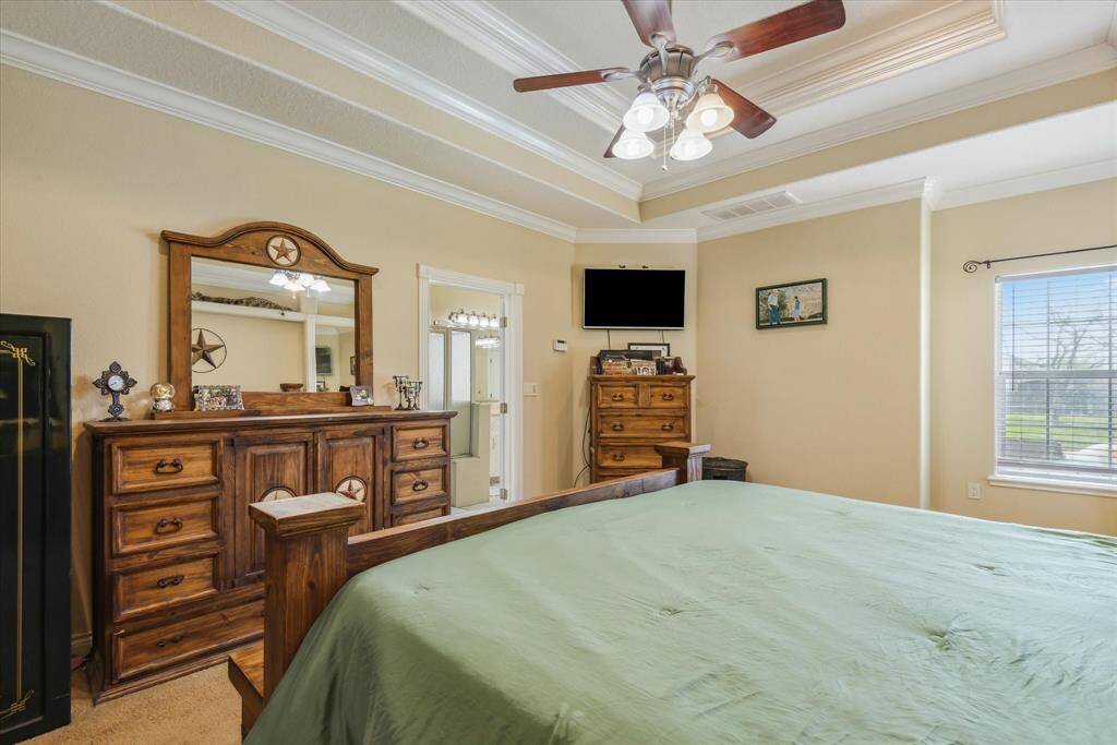 Primary bedroom with entrance to bathroom. There is enough room by the window for a little sitting area!