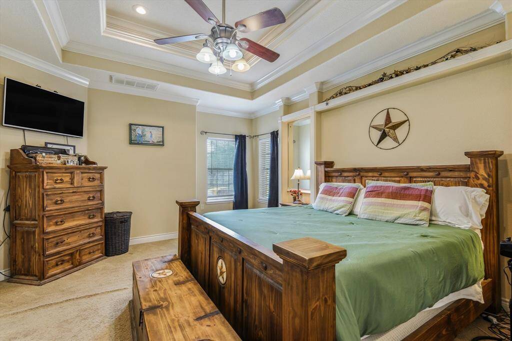 Primary bedroom with tray ceilings and corner that can be a sitting area.