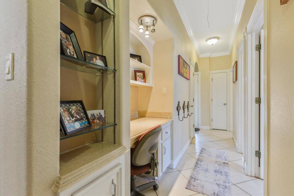 Adorable display cabinet and office area in the hallway.