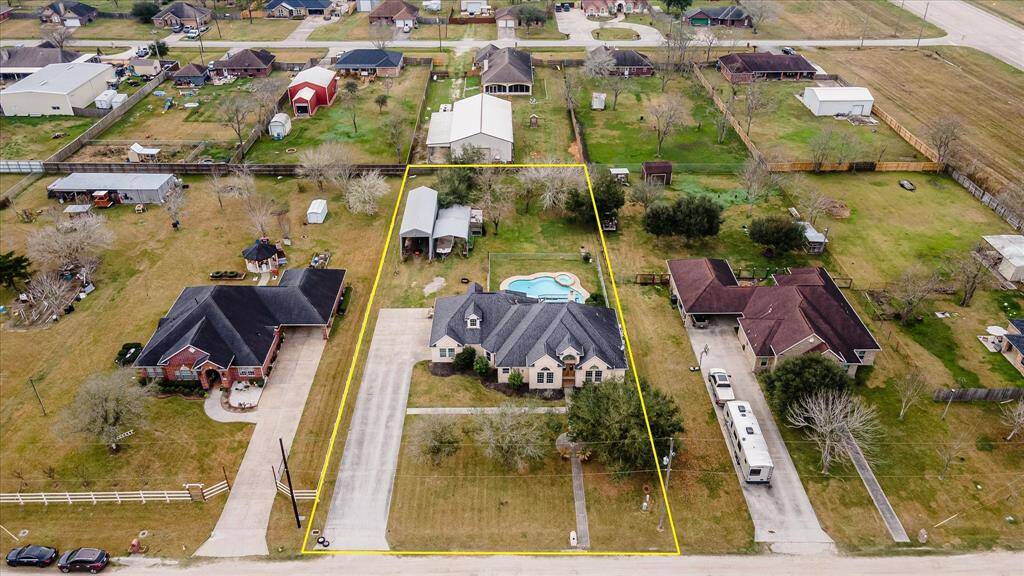 .72 acres with a custom-built home, inground pool, hot tub, RV barn, and AG barn.