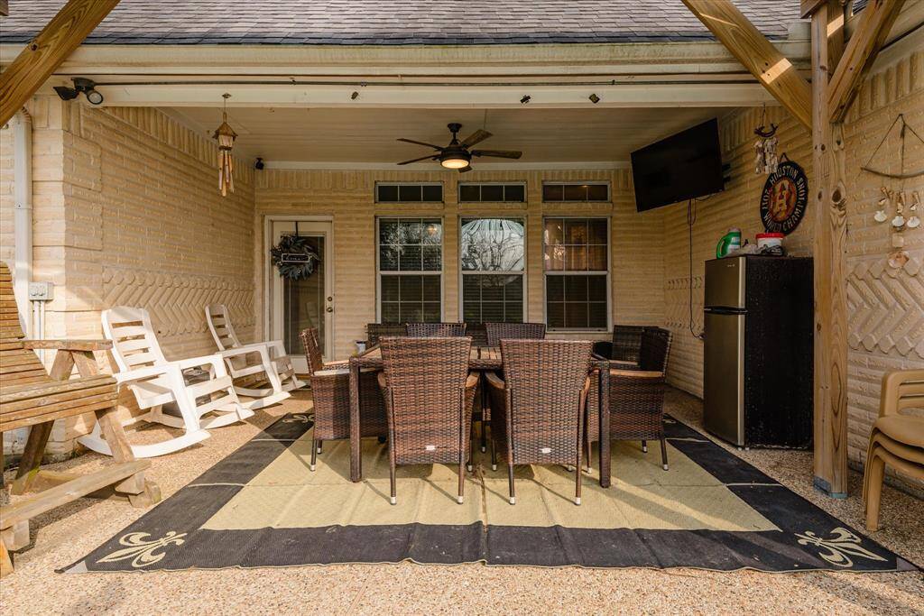 Covered back patio is perfect for relaxing by the pool!