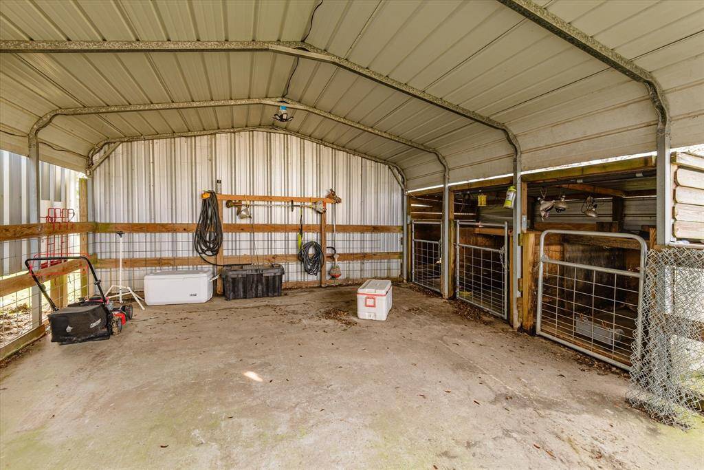 Inside of covered shop area and the AG barn to the right.