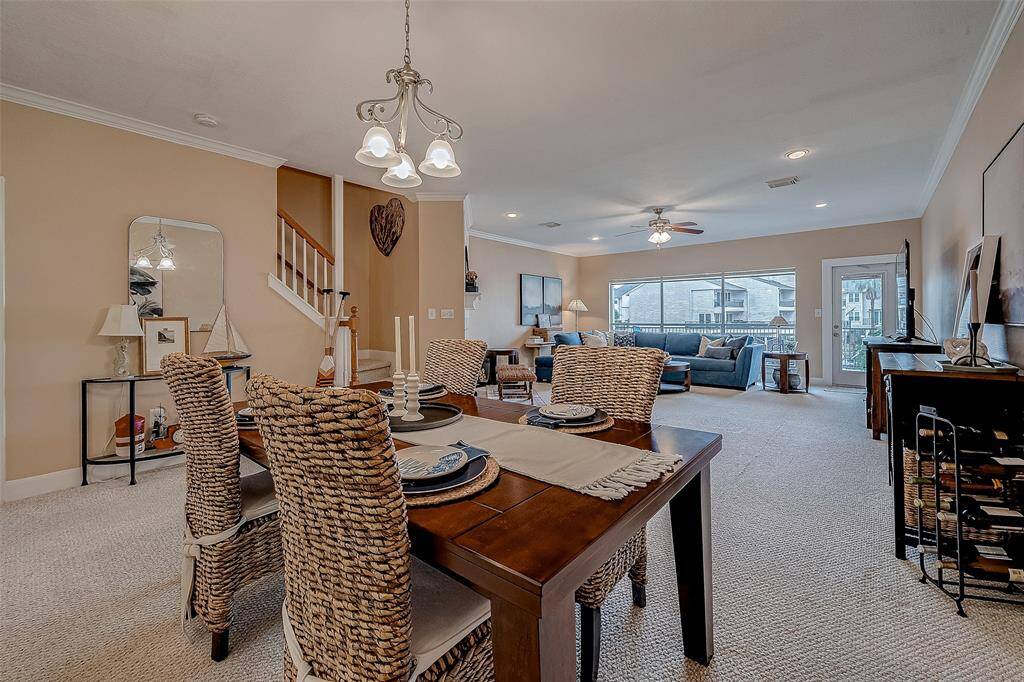 view from kitchen looking towards dining area and back deck overlooking the lake and marina