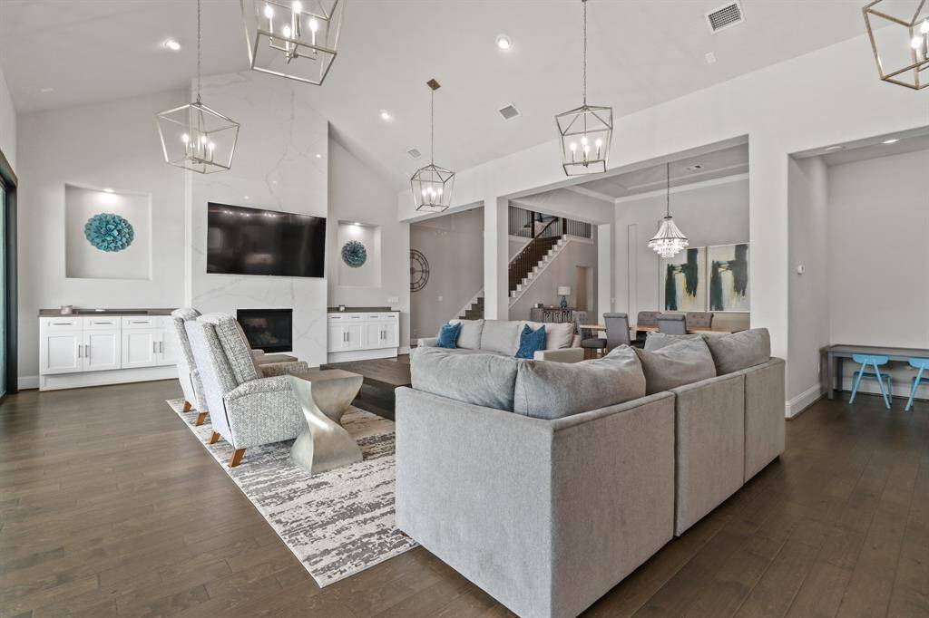 The Luxurious Living Room features high, slanted ceilings, lantern style lighting and built in cabinets.