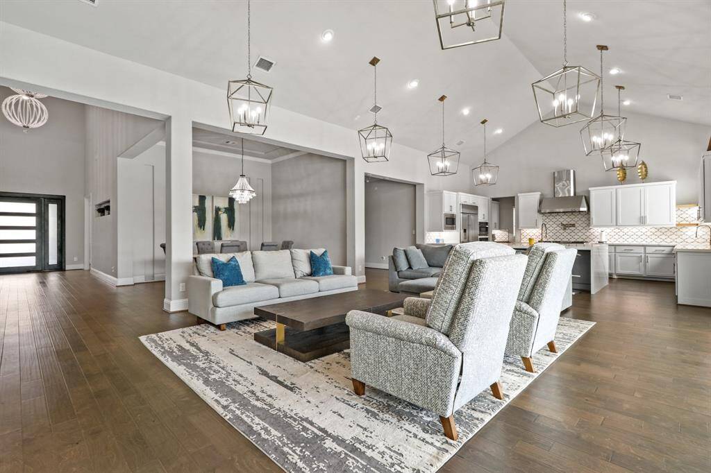 Another view of the open concept living spaces, starting with the custom front door, into the Divine Dining Room, the Luxurious Living Room and finally the Gourmet Kitchen.