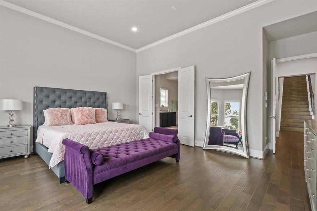 This spacious Primary Suite features handsome hardwood floors, bay windows offering a view of the beautiful backyard, and direct access to the peaceful Primary Bath Oasis.