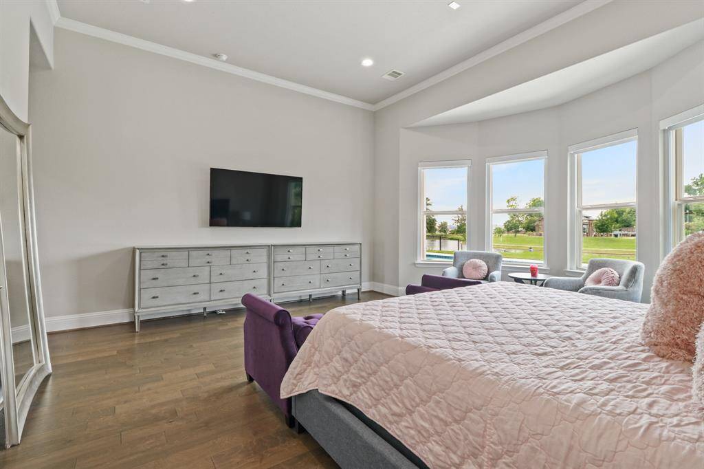 A wall of windows and room for extra seating are just a few of the features found in this Prestigious Primary Suite.