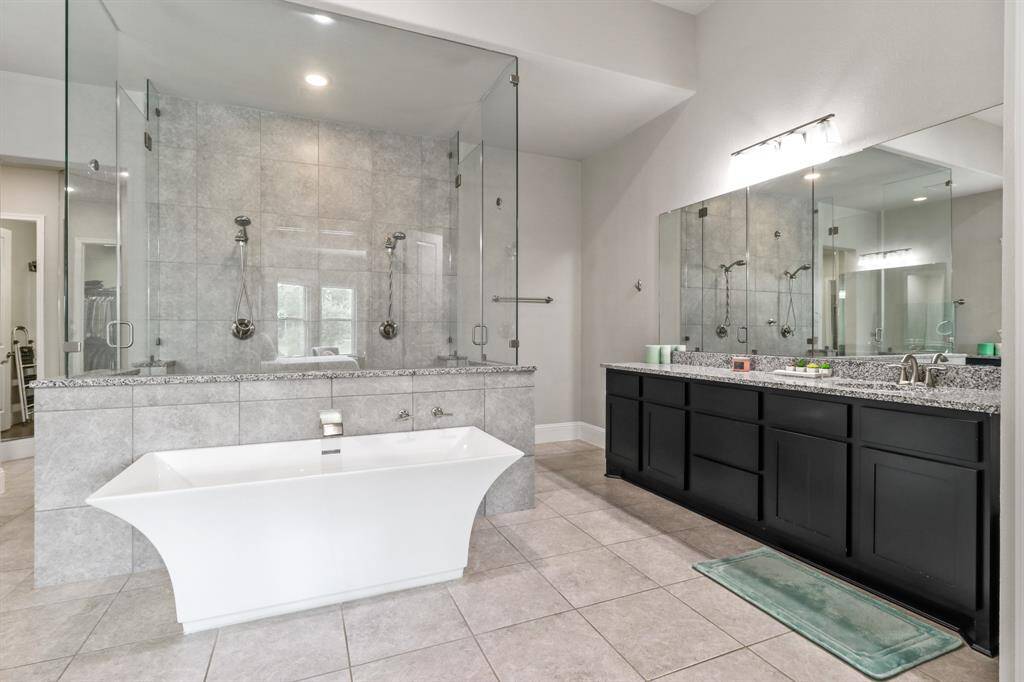 Start your day with a soak in this oversized garden tub, then get ready using the extended mirrors and vanity space.