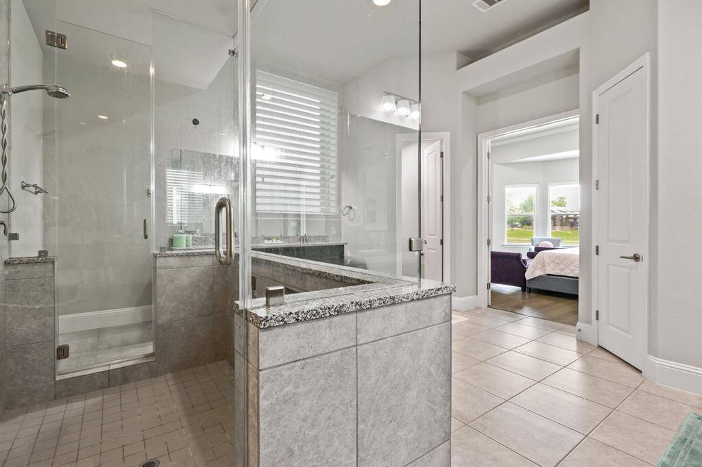 Dual showerheads, tile surround and a glass enclosure make this a fantastic place to wash away the day.