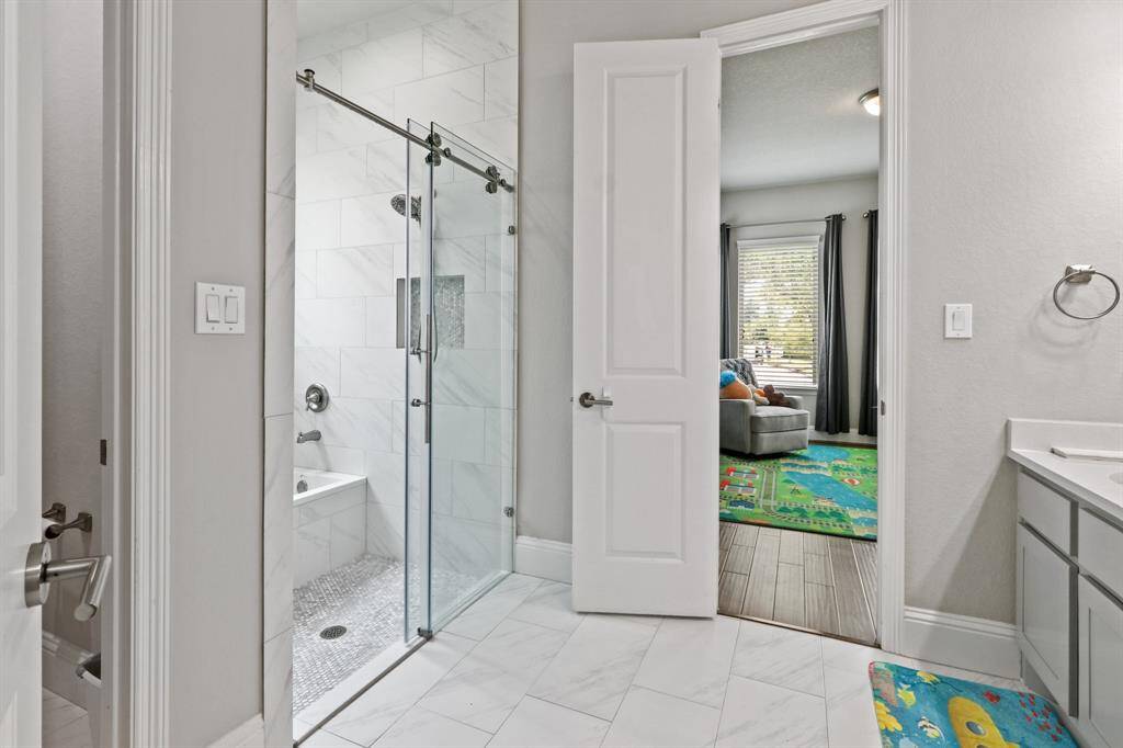 This Jack and Jill bath features a separate water closet as well as glass enclosed tub/shower combo, great for kids bath time!
