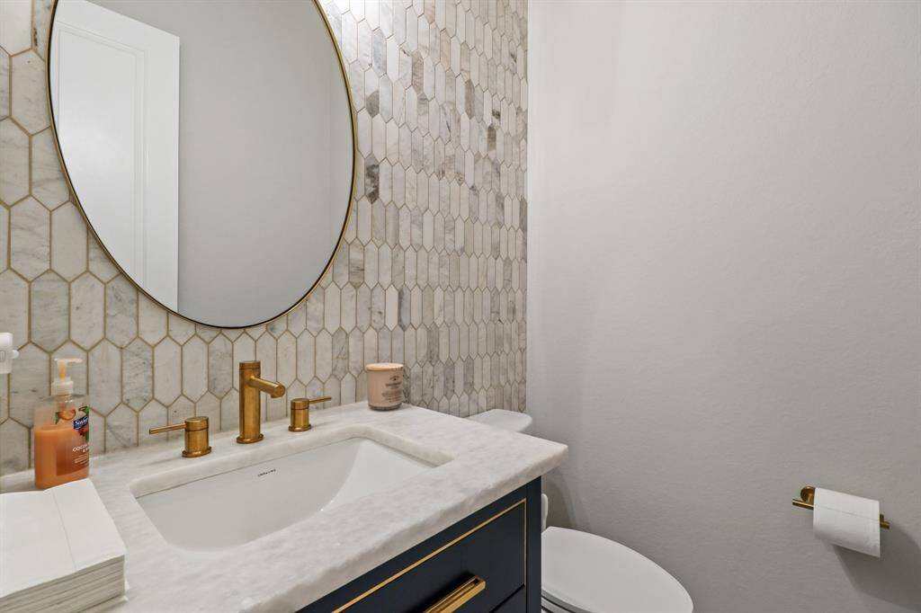 Tile Wall and Granite countertops complete this powder bath, great for guests!