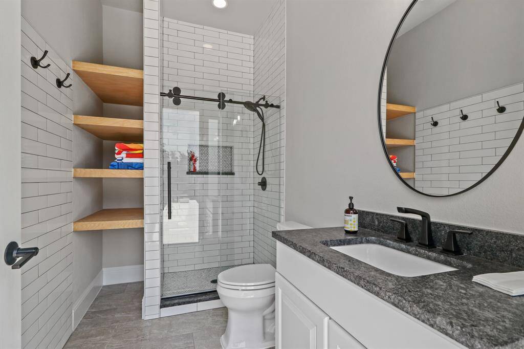 This Pool Bath makes for a great space to rinse off after a dip and comes complete with tile surround shower, granite countertops and additional storage for pool towels.