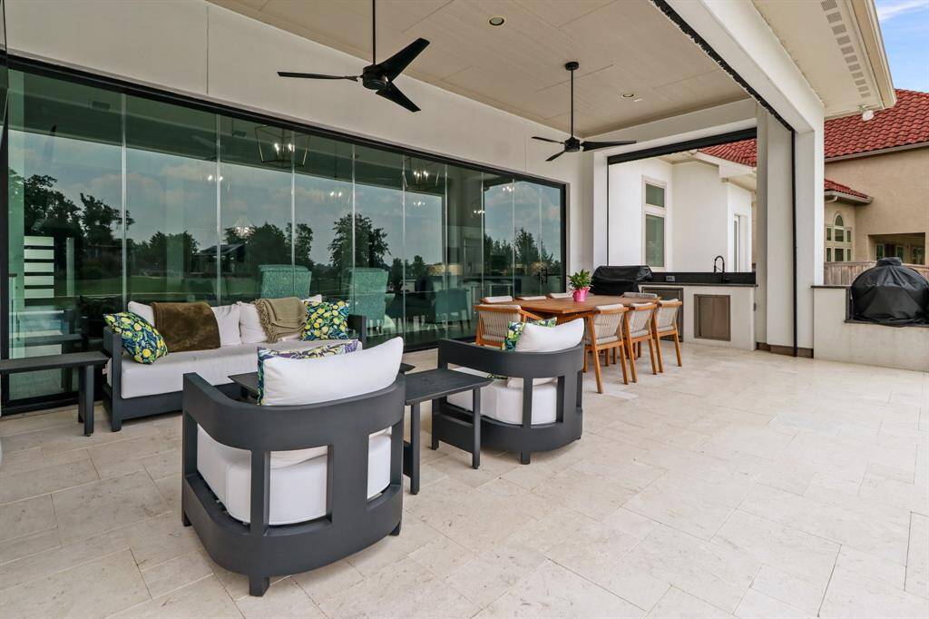 Enjoy the abundance of seating areas under the covered patio which features ceiling fans and an outdoor kitchen!