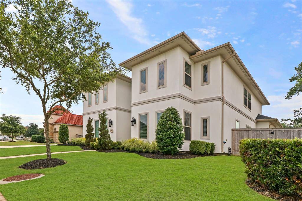 This Superior Stucco exterior home is surrounded by lush landscaping and maturing trees.