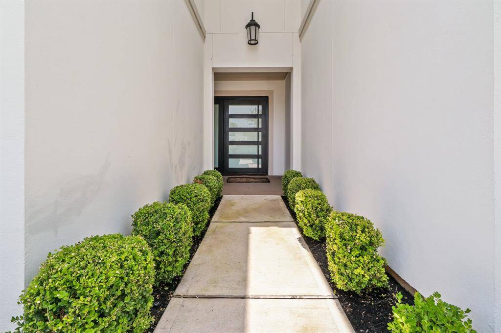 Gorgeous Greenery greets you as you approach the custom front door.