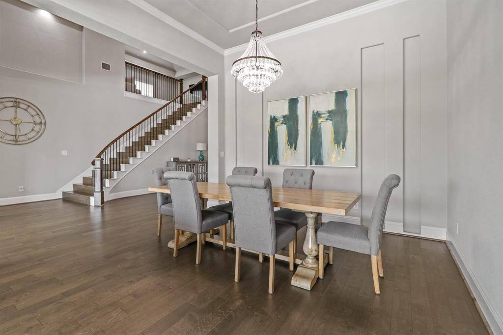 Welcome to the Divine Dining Room featuring tray ceilings, charming chandelier and handsome hardwood flooring, an ideal place to host dinner parties!