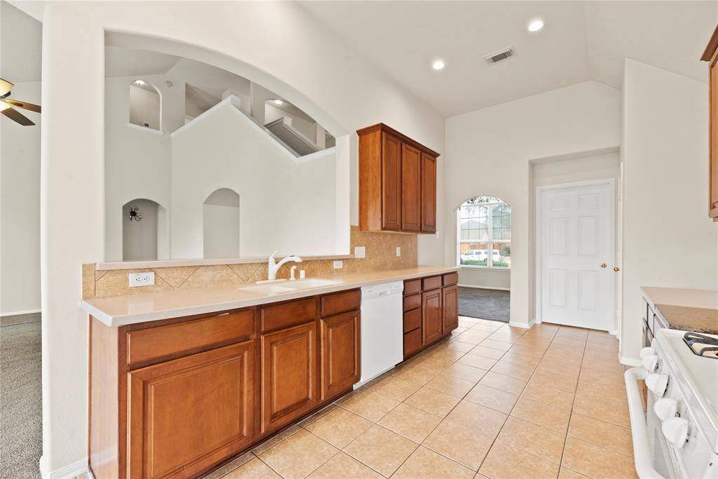 Corian countertops paired with a coordinating stone backsplash not only provide a durable and elegant surface for food preparation but also add a touch of luxury and sophistication to the kitchen.