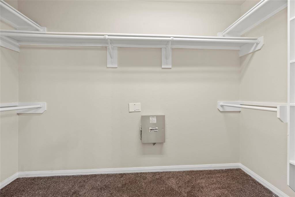 The primary closet offers ample space to store all your clothes and keep everything organized.