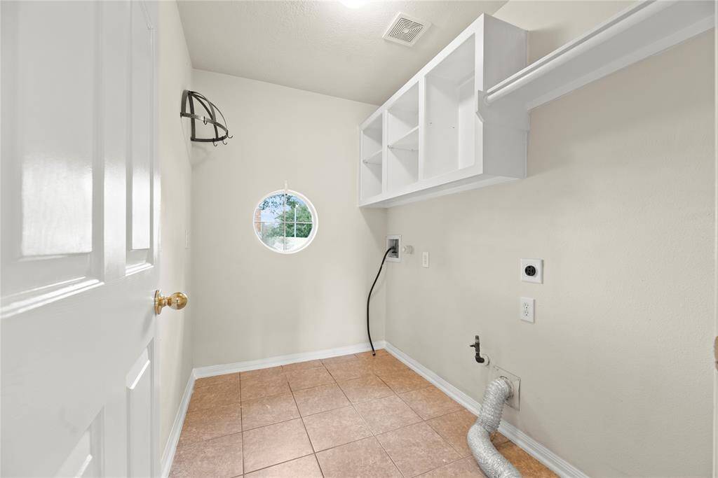This well-appointed utility space includes ample storage and efficient organization, making laundry day a breeze while keeping your home tidy and functional.