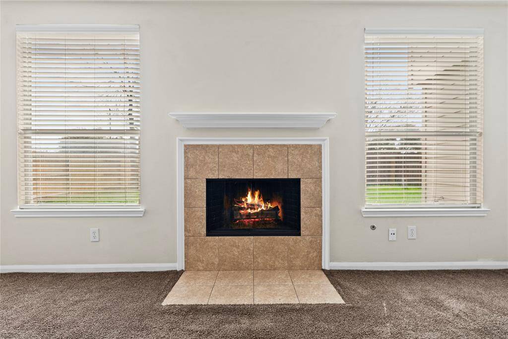 The inviting fireplace becomes a focal point that anchors the room and invites people to gather and linger, making it a cherished feature of the living area.