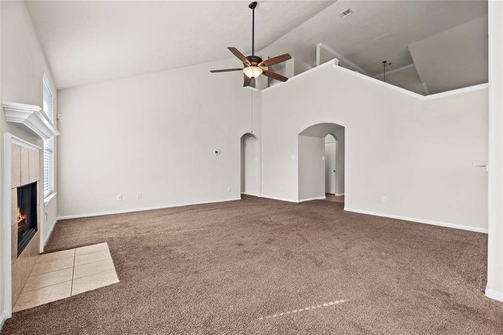 The living room, adjacent to the kitchen and breakfast area, offers a comfortable and inviting space for relaxation and socializing.