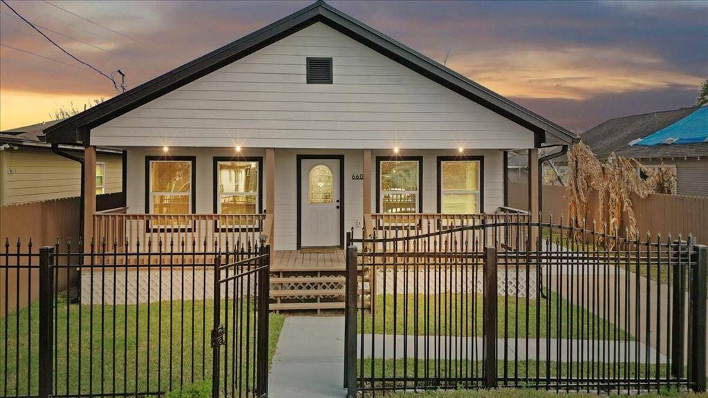 Discover this charming, fully gated home featuring a welcoming front porch, spacious driveway, and a secure, private yard. Perfect for comfortable living and peace of mind.