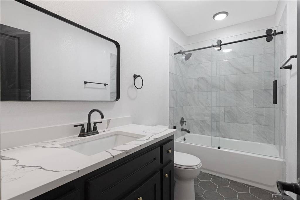 Luxurious full bath featuring elegant fixtures, a sleek vanity, and a modern tiled shower for ultimate comfort.