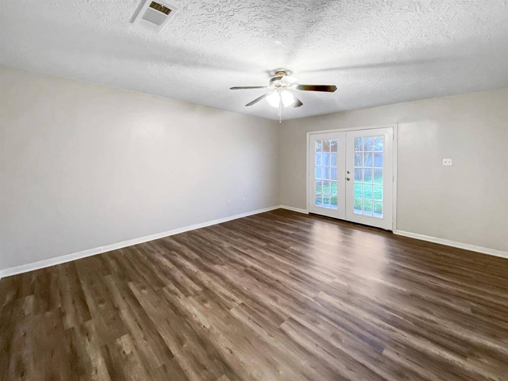 The master bedroom features a private covered patio that overlooks the backyard.