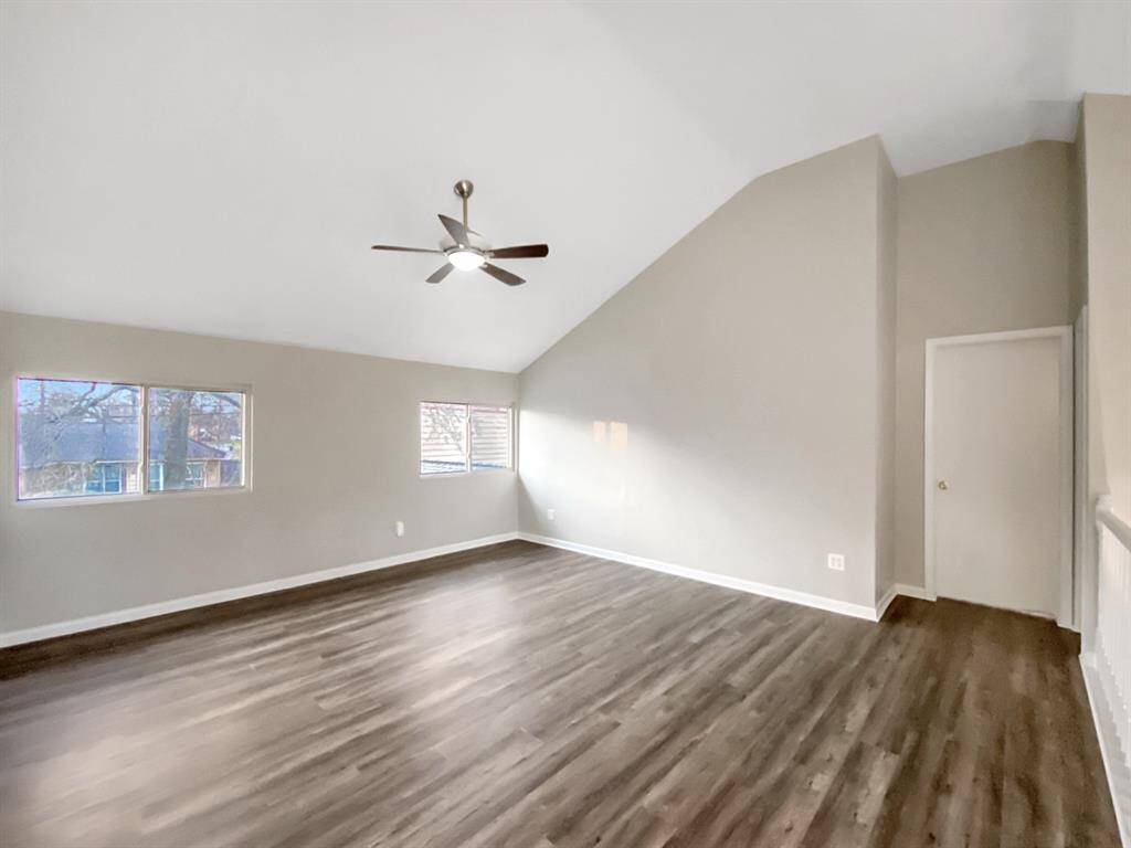 Spacious open room at the top of the stairs, perfect for multiple uses.