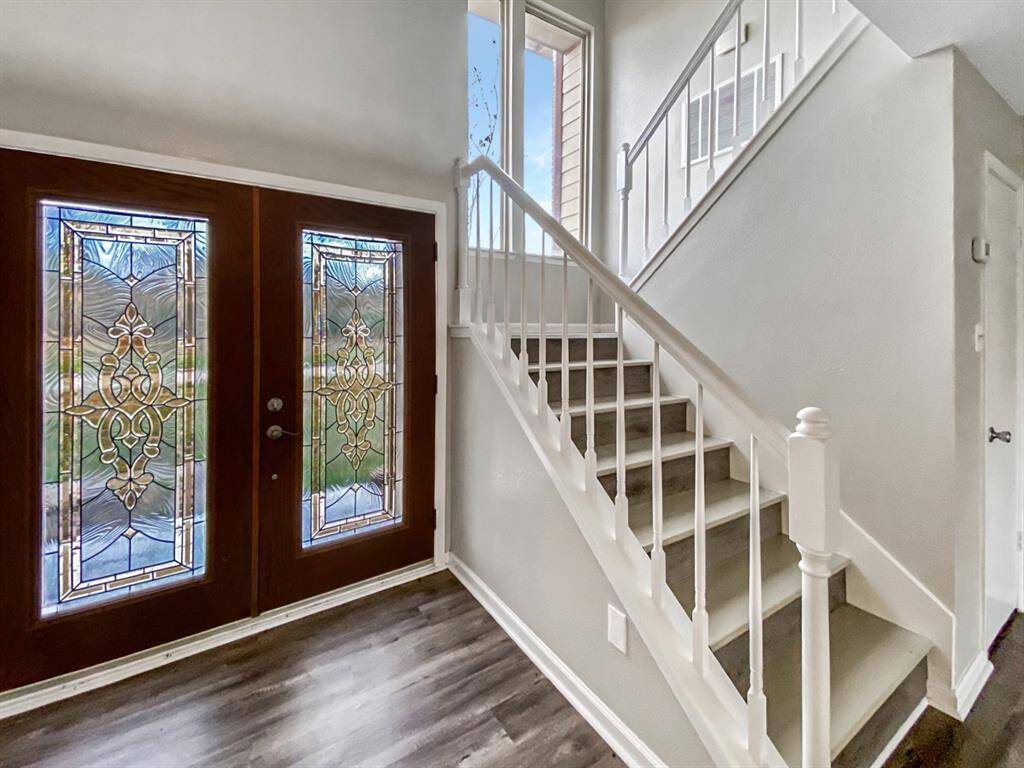 Welcoming entry with elegant stained glass doors.