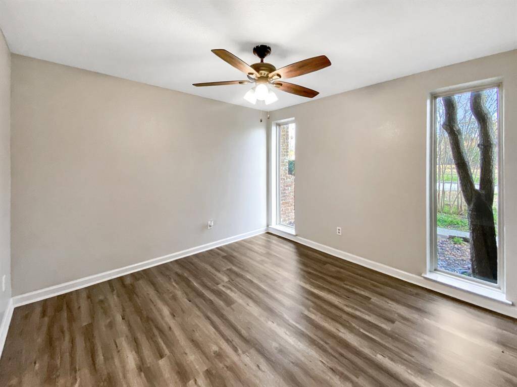 Formal dining room with tall windows, filling the space with natural light.