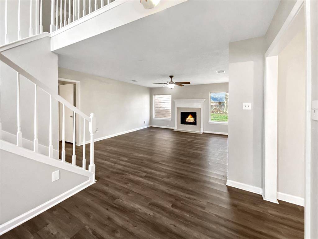 Spacious living room with wood-burning fireplace.