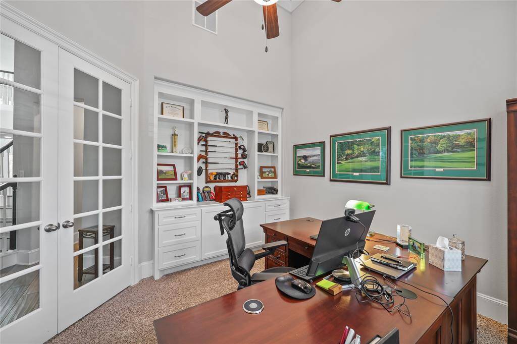 The study is further enhanced by French doors and custom shelving and cabinets/drawers.