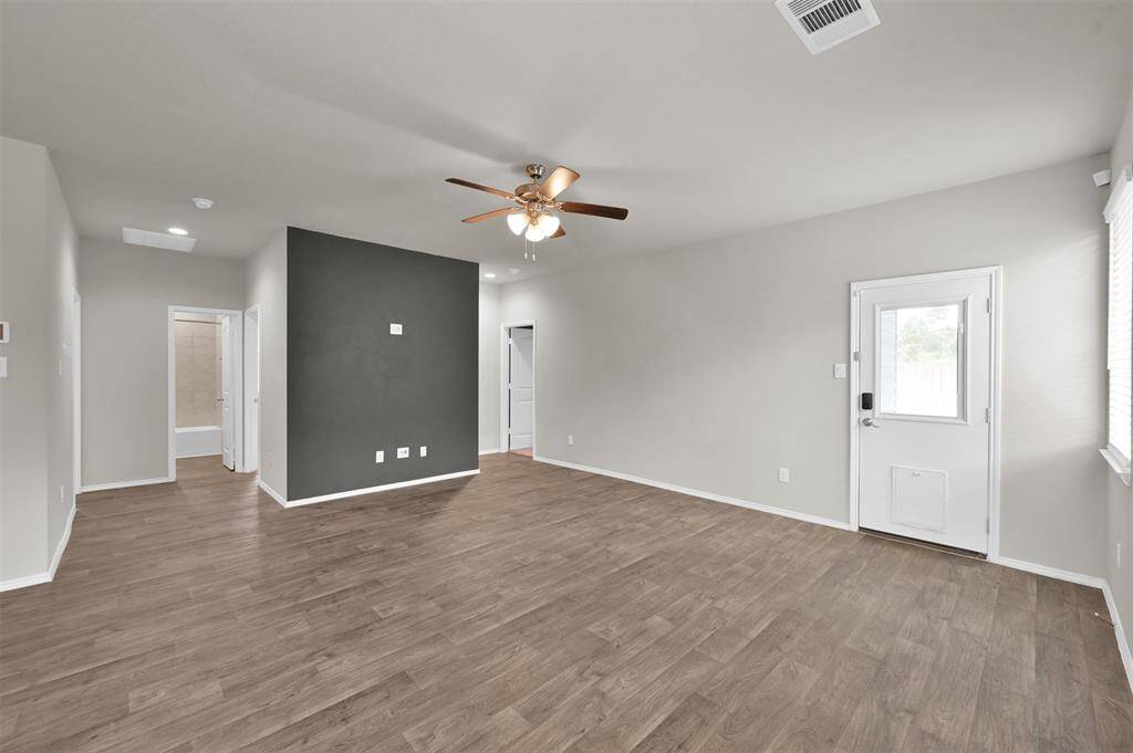 Living area with exterior door leading to the extended covered patio!