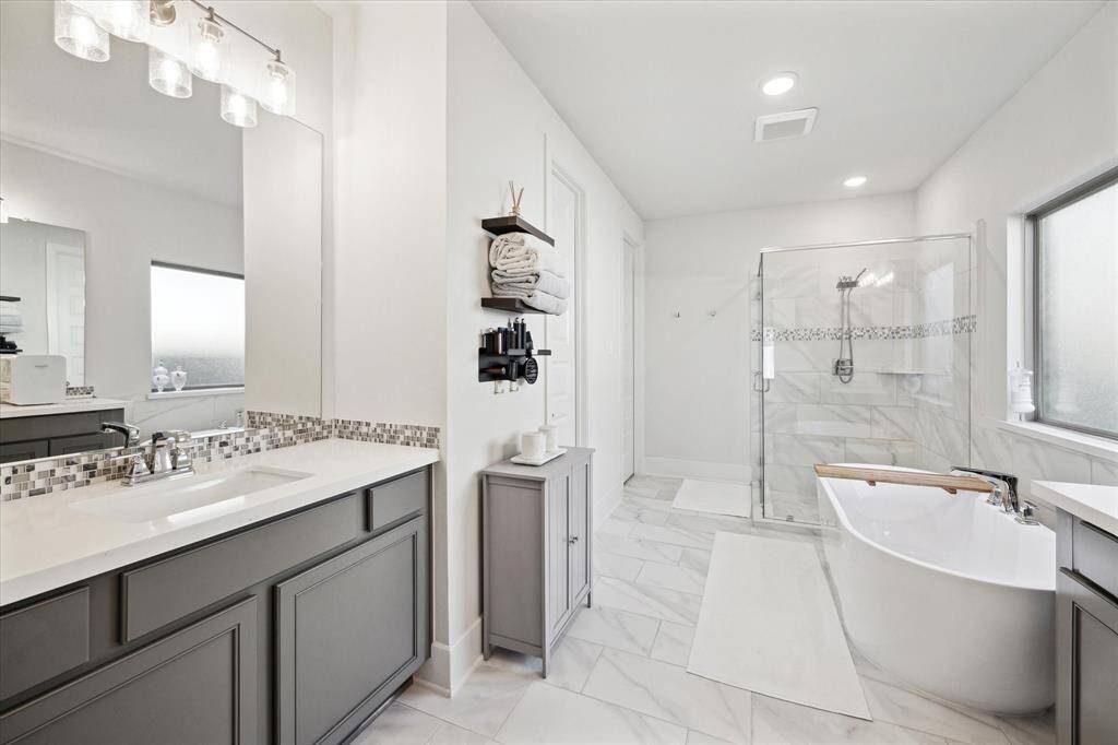 The master bathroom has two separate vanities, shower and soaking tub!