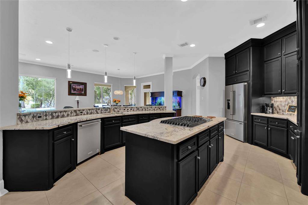 The kitchen features ample counter space and abundant cabinetry with cabinetery extending all the way to the ceiling for maximum storage space.