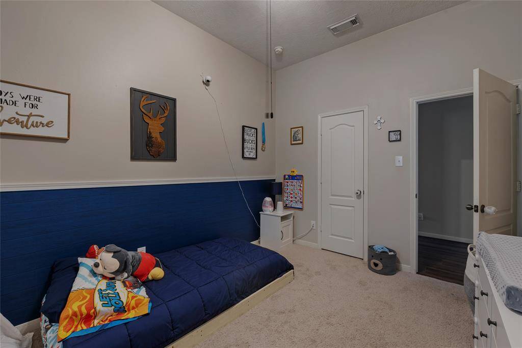 VERY large secondary bedroom at front of the home. Perfect space for 1 (or multiple) kids, or an inviting guest bedroom. **Blue "shiplap" is easily removable!**