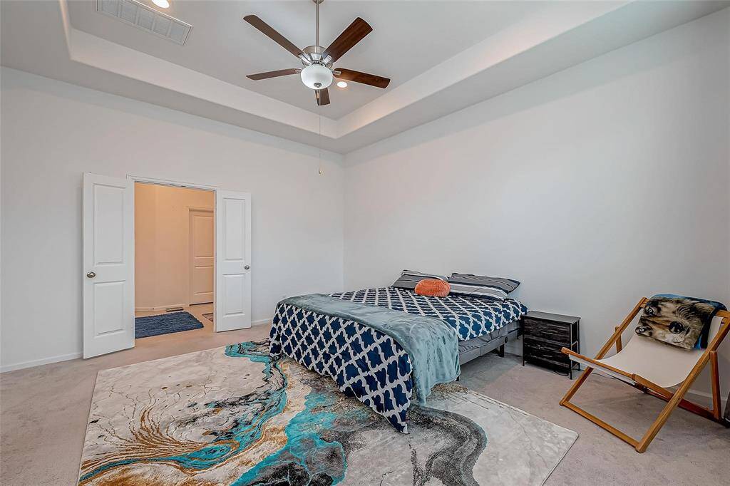 Primary bedroom is spacious with beautiful windows allowing natural light.