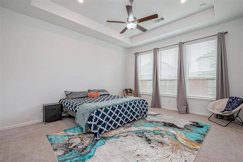 Primary bedroom is spacious with beautiful windows allowing natural light.