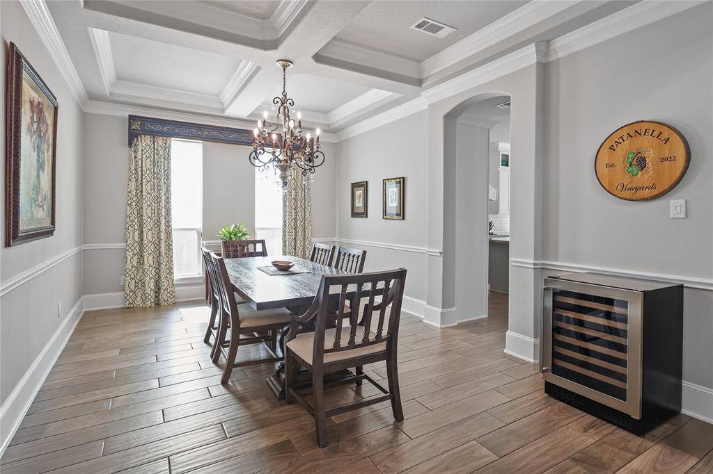 The open layout seamlessly flows into the kitchen. Wood-look tile flooring adds a modern touch while maintaining a cozy atmosphere.