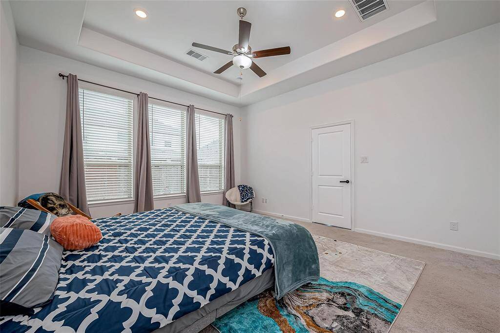 Primary bedroom is spacious with beautiful windows allowing natural light.