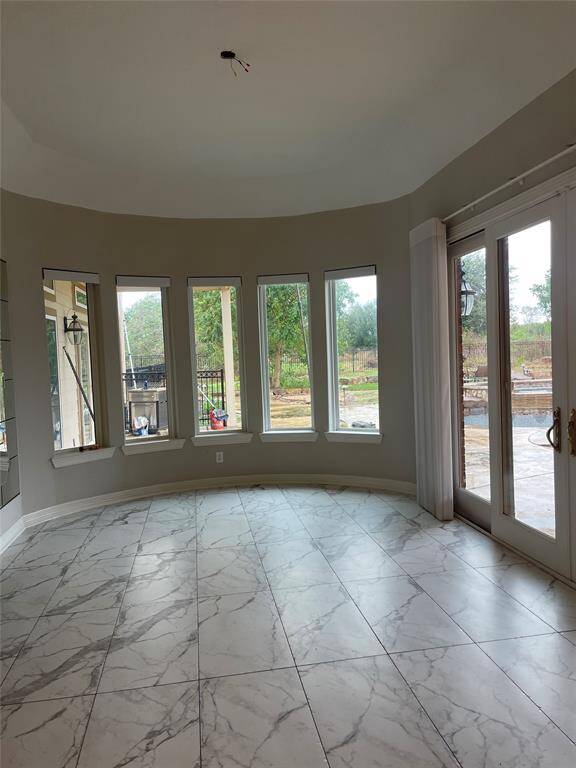 Dining area with bay windows overlooking property and pool area
