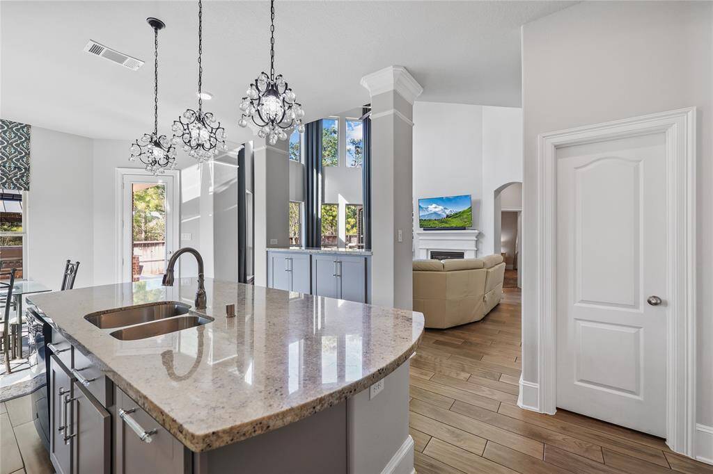 The oversized island, with bar seating, adorned with luxurious granite countertops and stylish pendant lighting, is the perfect centerpiece for entertaining.