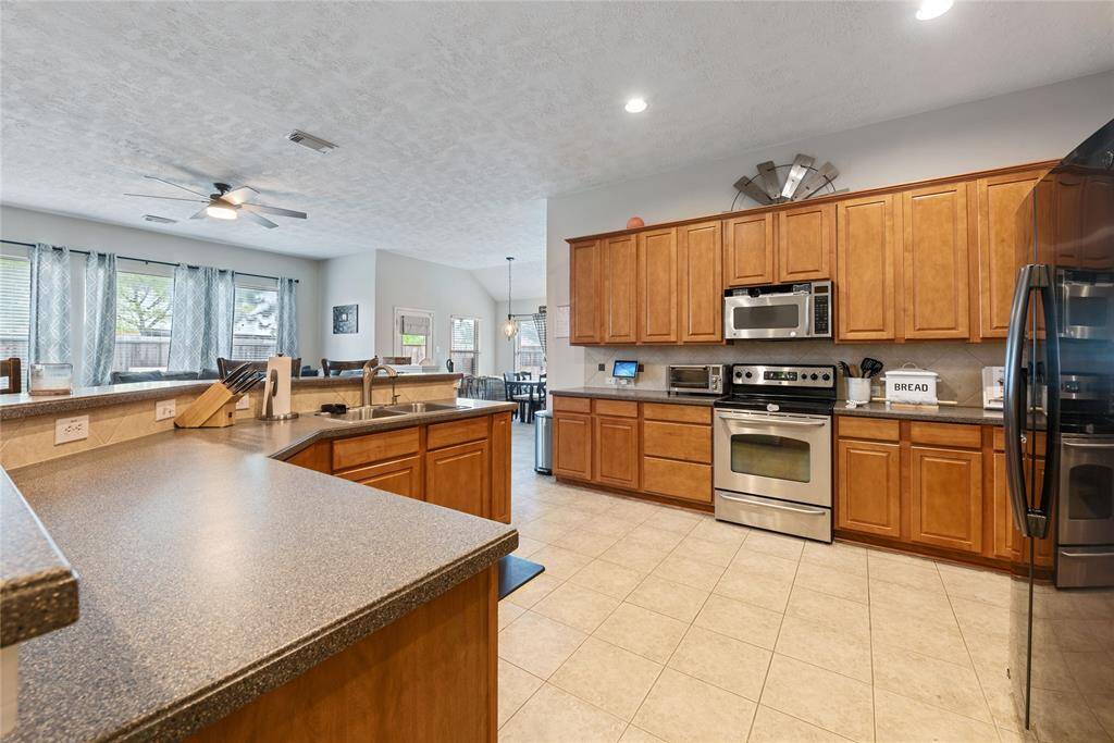 Oversized, multi-level island space with multiple outlets, sink and dishwasher allow visuals to living room, eating area, and back yard for a more inclusive and enjoyable experince in the kitchen!